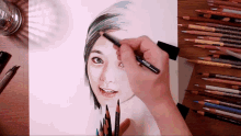 a person is drawing a woman 's face with colored pencils and a marker that says prismacolor