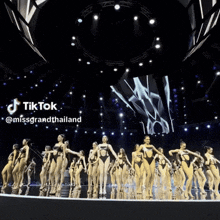 a group of women in swimsuits are dancing on a stage with a tiktok watermark