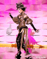 a woman in a costume is standing on a stage with a purse in her hand .