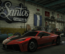 a red sports car is parked in a garage with a sign that says santos customs on it