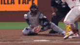 a baseball game is being played in front of an illa tape sign