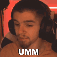 a man wearing headphones is making a funny face while sitting in a chair .
