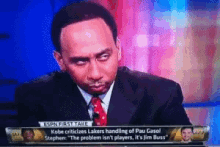 a man in a suit and tie is talking on espn