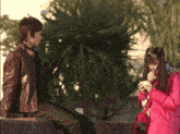 a man and a girl are sitting next to each other in a park