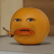 an orange with a violin in its mouth and red lips