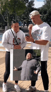 a man wearing a shirt that says lovers on it looks at his phone