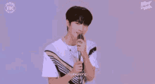 a young man is singing into a microphone with the words come along written on the bottom