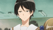 a girl with short black hair and a white shirt has a serious look on her face