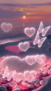 hearts and butterflies are floating in the air on a beach
