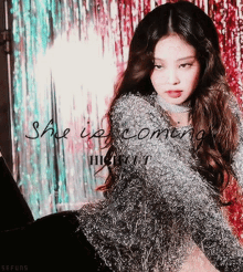 a girl in a sweater with the words she is coming written on it