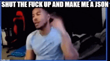 a man is sitting in front of a computer screen with the words `` shut the fuck up and make me a json ''