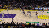 a basketball game is being played in front of a crowd and a sign that says " get the a "