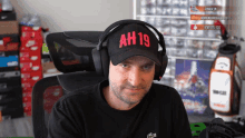 a man wearing headphones and a hat that says ah19 on it