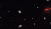 a red light is coming out of a rock in the dark