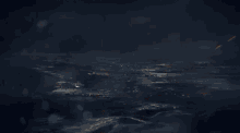 a lightning bolt is shining over a body of water in the dark .