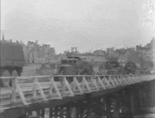 a black and white photo of a bridge over a river