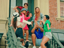 a group of people are standing on a set of stairs