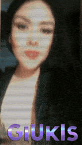 a blurred image of a woman with the name giukis written in purple