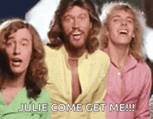 a group of three men are standing next to each other and singing julie come get me !!