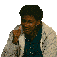 a man wearing a gray hoodie and a blue shirt is smiling and giving a thumbs up