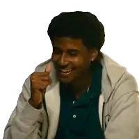 a man wearing a gray hoodie and a blue shirt is smiling and giving a thumbs up