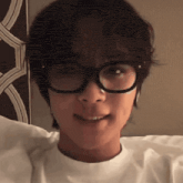 a person wearing glasses and a white shirt