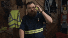 a man with a beard is talking on a cell phone and the words you 're allowed are above him