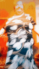 a blurred image of a person with tiktok written on the bottom right