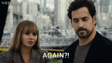 a man and a woman are standing next to each other and the man is saying " again "