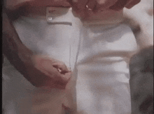 a close up of a person 's pants being buttoned up .