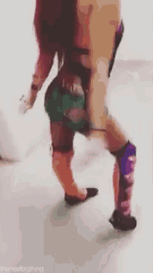 a woman is standing on a white floor wearing knee pads .