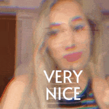 a blurry picture of a woman with the words " very nice " on the bottom