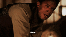 a man says meow while laying on the ground