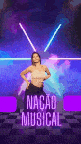 a woman is dancing in front of a sign that says nacao musical on it