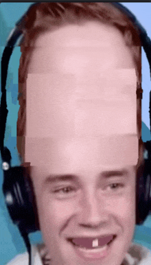 a man wearing headphones has a missing teeth