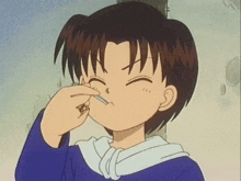 a boy in a blue shirt is holding a cigarette in his mouth