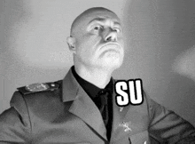 a man in a military uniform has the word su on his collar