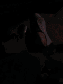 a blurry picture of a person 's arm with a light behind them