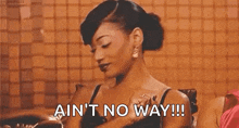 a woman is sitting in a chair with her hands on her chest and the words `` ain 't no way ! ''