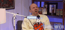 a man is sitting in front of a microphone with the words dark web on the bottom