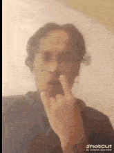 a man wearing headphones is giving the middle finger .