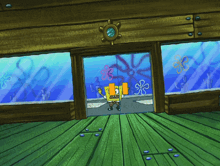a cartoon of spongebob standing in front of a aquarium