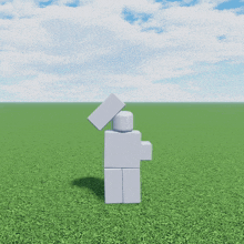 a white lego figure is standing in a field