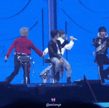 a group of people on a stage with the word wooongz on the bottom right
