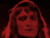 a close up of a person 's face in red