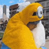 a man in a minion costume is hugging another person