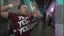 a man wearing a red shirt that says yes on it