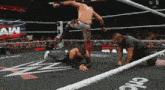 a man in a wrestling ring with the letters aw on the wall