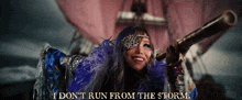a woman holding a telescope with the words " i don t run from the storm " written below her