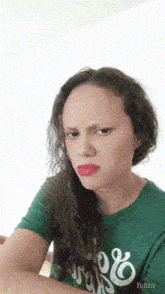 a girl wearing a green shirt that says ' yulizie ' on the bottom
